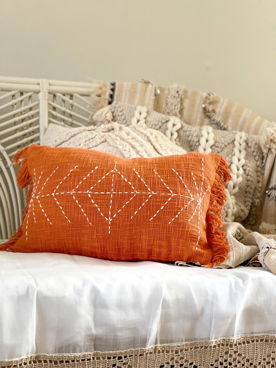 orange cotton cushion with embroidered detail