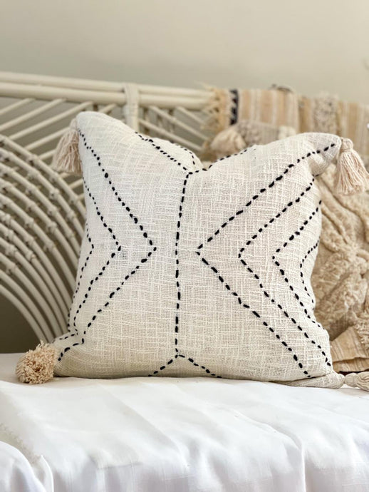 white cotton cushion with embroidered detail
