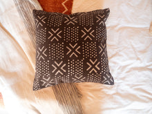 Load image into Gallery viewer, top view of mudcloth cushion with spots and crosses pattern
